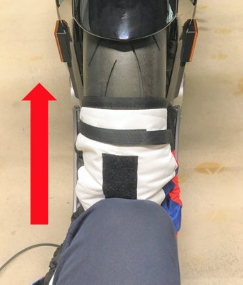You see how the tire warmer is pressed against the tire with the knee.